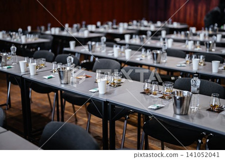 Elegant banquet setup with glasses, bottles, and refreshments before an event Elegant banquet setup with glasses, bottles, and refreshments before an event 141052041