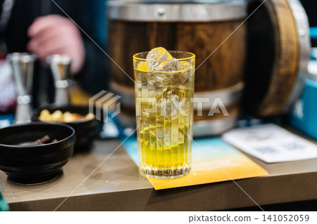 Refreshing cocktail with vibrant colors served at a trendy bar Refreshing cocktail with vibrant colors served at a trendy bar 141052059
