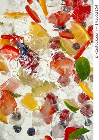 Mixed fruit lemonade with berries citrus mint and ice cubes. Mixed fruit lemonade with berries citrus mint and ice cubes. 141052154