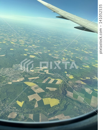 View of the ground from inside the plane View of the ground from inside the plane 141052535