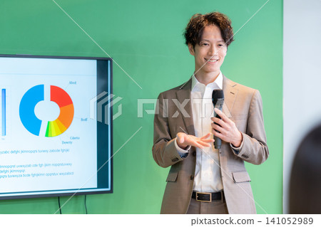A consultant giving a seminar in a conference room. A consultant giving a seminar in a conference room. 141052989