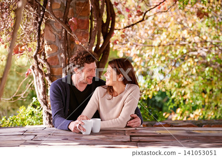 Spring, relax and couple embrace with coffee cups on table in nature, environment and together for romance. Partners, woman and man with hand from girl, hug and touch for love in marriage and park Spring, relax and couple embrace with coffee cups on table in nature, environment and together for romance. Partners, woman and man with hand from girl, hug and touch for love in marriage and park 141053051