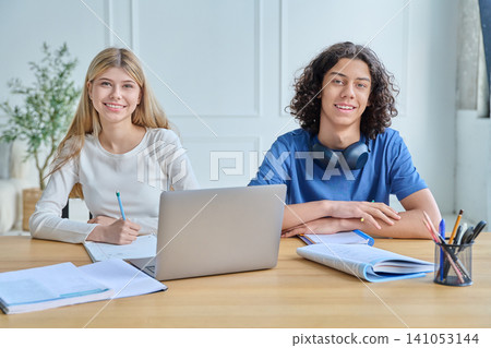 Happy teen students studying with laptop at home Happy teen students studying with laptop at home 141053144