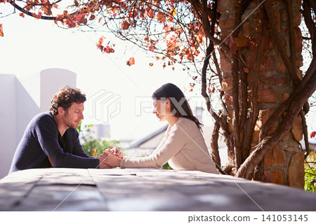 Outdoor, spring and couple holding hands on table in nature, environment and together for romance. Partners, woman and man with compassion from girl, care and touch for love in marriage and park Outdoor, spring and couple holding hands on table in nature, environment and together for romance. Partners, woman and man with compassion from girl, care and touch for love in marriage and park 141053145