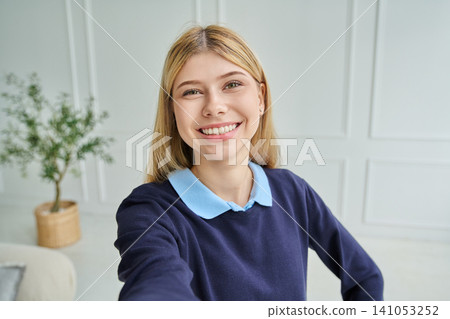 Smiling teen girl aged 16-17 taking a selfie 141053252