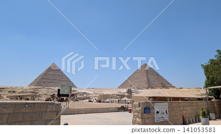 The pyramids and Sphinx with camels and carriages The pyramids and Sphinx with camels and carriages 141053581