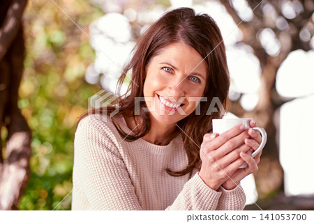 Portrait, smile and woman drinking coffee, cappuccino or espresso in backyard garden of home. Bokeh, morning and face of female person with cup of tea for relax, peace and happiness in nature Portrait, smile and woman drinking coffee, cappuccino or espresso in backyard garden of home. Bokeh, morning and face of female person with cup of tea for relax, peace and happiness in nature 141053700