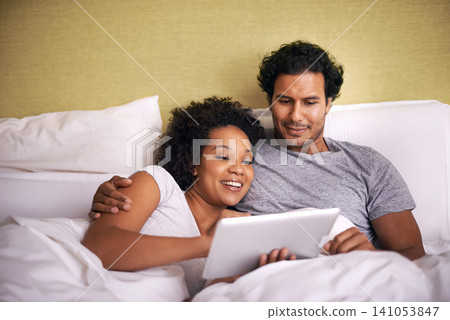 Bed, woman and man relax with tablet, cuddle and rest on soft mattress, love and romance for couple. Partners, male person and girl in bedroom, happy and together in pyjamas, break and weekend Bed, woman and man relax with tablet, cuddle and rest on soft mattress, love and romance for couple. Partners, male person and girl in bedroom, happy and together in pyjamas, break and weekend 141053847