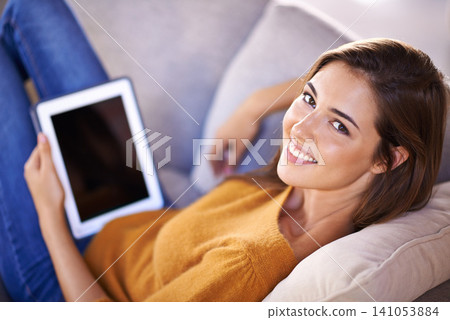 Woman, portrait and relax on couch with tablet for internet browsing or social media, online shopping and website. Female person, digital technology and sofa to lounge with connectivity and peaceful. Woman, portrait and relax on couch with tablet for internet browsing or social media, online shopping and website. Female person, digital technology and sofa to lounge with connectivity and peaceful. 141053884
