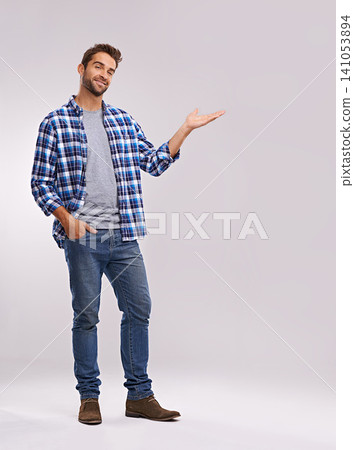 Portrait, presentation and creative man in studio with smile, deal announcement and product placement. Showing, advice and casual person pointing at offer, notification and white background mockup Portrait, presentation and creative man in studio with smile, deal announcement and product placement. Showing, advice and casual person pointing at offer, notification and white background mockup 141053894
