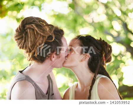 Outdoor, kiss and couple with love, nature and romance with marriage and bonding together with care. Date, man and woman in a park, summer and relationship with happiness and affection with peace Outdoor, kiss and couple with love, nature and romance with marriage and bonding together with care. Date, man and woman in a park, summer and relationship with happiness and affection with peace 141053952