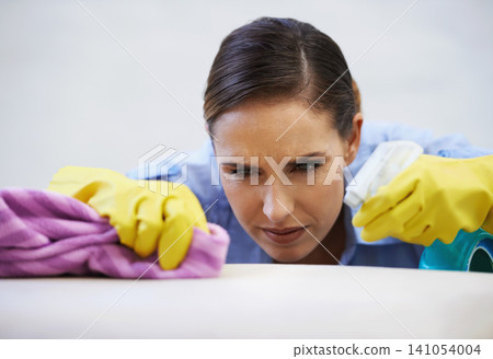 Woman, gloves and spray for cleaning table in home, disinfection and remove dirt or bacteria and dust. Female person, housekeeeping and wash with detergent or sanitation, maid and chemical for germs Woman, gloves and spray for cleaning table in home, disinfection and remove dirt or bacteria and dust. Female person, housekeeeping and wash with detergent or sanitation, maid and chemical for germs 141054004