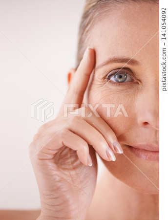 Mature, half or woman with skincare, portrait and cosmetics for facial treatment, confidence or wellness. Female model, studio and person with beauty glow for anti aging results on white background Mature, half or woman with skincare, portrait and cosmetics for facial treatment, confidence or wellness. Female model, studio and person with beauty glow for anti aging results on white background 141054092