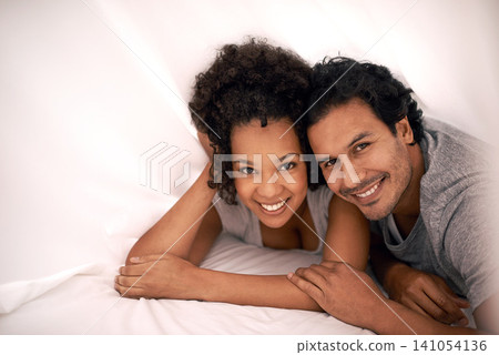 Couple, portrait and bed with sheet for relax morning or calm for partnership cozy, bonding or apartment. Man, woman and happy under linen or honeymoon love for vacation getaway, carefree or peaceful Couple, portrait and bed with sheet for relax morning or calm for partnership cozy, bonding or apartment. Man, woman and happy under linen or honeymoon love for vacation getaway, carefree or peaceful 141054136