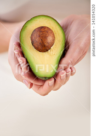 Hands, avocado and vegetable diet for antioxidants, nutrition and minerals or vitamins for health. Closeup, person and holding vegan food for green detox, superfoods and holding for organic skincare Hands, avocado and vegetable diet for antioxidants, nutrition and minerals or vitamins for health. Closeup, person and holding vegan food for green detox, superfoods and holding for organic skincare 141054320