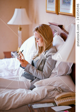 Business, woman and technology on bed with planning for corporate research, digital tablet and work schedule. Professional, person and touchscreen for writing review notes or internet search in hotel Business, woman and technology on bed with planning for corporate research, digital tablet and work schedule. Professional, person and touchscreen for writing review notes or internet search in hotel 141054346