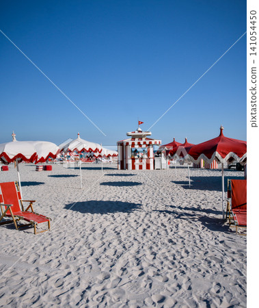 Red and White Striped Beach Cabanas With Empty Loungers Red and White Striped Beach Cabanas With Empty Loungers 141054450