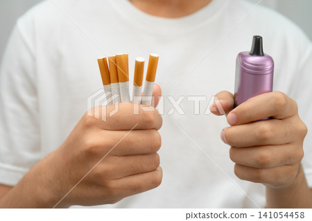 Man holding electronic cigarettes, no smoking. Man holding electronic cigarettes, no smoking. 141054458