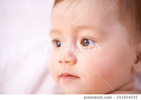 Closeup, girl and baby on bed with curiosity for childhood development, growth and relax in nursery. Newborn, ginger and kid with wonder for wellness, knowledge and calm child in bedroom from above 141054535