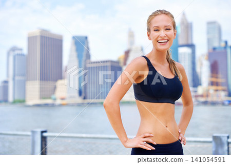 Woman, city and smile at river in sportswear with break for jog, fitness and healthy mind in New York. Portrait, female person and happy with self care in summer, hot weather and confident Woman, city and smile at river in sportswear with break for jog, fitness and healthy mind in New York. Portrait, female person and happy with self care in summer, hot weather and confident 141054591
