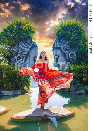 happy beautiful tourist girl at statue with faces in the famous tourist attraction Clay Tunnel Sculptures in Dalat in Vietnam happy beautiful tourist girl at statue with faces in the famous tourist attraction Clay Tunnel Sculptures in Dalat in Vietnam 141054607