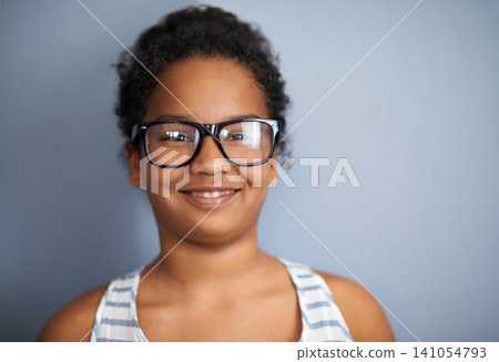 Happy child, girl and portrait in studio with glasses, education and pride in school or academic excellence. Kid, face and smile in prescription eyewear to support learning, eyecare and ophthalmology Happy child, girl and portrait in studio with glasses, education and pride in school or academic excellence. Kid, face and smile in prescription eyewear to support learning, eyecare and ophthalmology 141054793