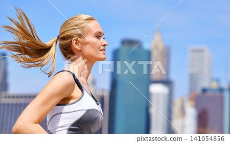 Woman, outside and running for fitness in city, jogging active and fit female person exercise in New York. Energy, wellness marathon for sports training and workout for athlete, cardio for endurance Woman, outside and running for fitness in city, jogging active and fit female person exercise in New York. Energy, wellness marathon for sports training and workout for athlete, cardio for endurance 141054856