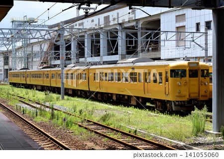 Four 115 series 3000 series train cars parked in the station premises. Four 115 series 3000 series train cars parked in the station premises. 141055060