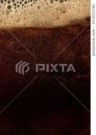 Dark beer foam texture with dense bubbles and rich stout layer. Dark beer foam texture with dense bubbles and rich stout layer. 141055190