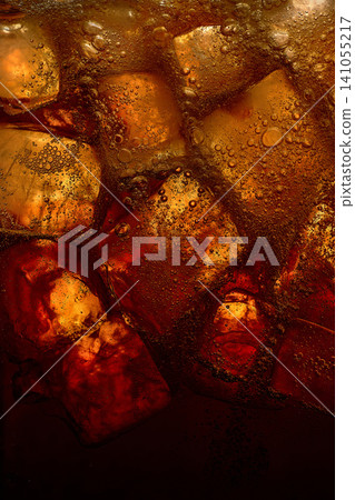 Glowing ice cubes in dark carbonated soda drink texture. Glowing ice cubes in dark carbonated soda drink texture. 141055217