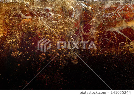 Iced caramel soft drink with sparkling bubbles and dark texture. Iced caramel soft drink with sparkling bubbles and dark texture. 141055244