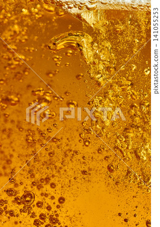 Golden beer bubbles macro texture with sparkling amber foam. Golden beer bubbles macro texture with sparkling amber foam. 141055253