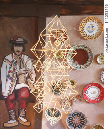 Traditional Folk Interior with Handmade Straw Ornament and Decorative Ceramic Plates Traditional Folk Interior with Handmade Straw Ornament and Decorative Ceramic Plates 141055266