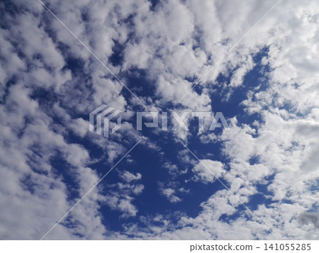 Fluffy white clouds floating in the blue autumn sky Fluffy white clouds floating in the blue autumn sky 141055285
