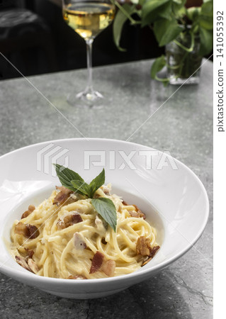 spaghetti carbonara creamy pasta with bacon and chesse on restaurant table 141055392