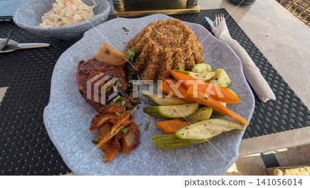 An Egyptian platter with seasoned rice, vegetable moussaka, and cooked vegetables An Egyptian platter with seasoned rice, vegetable moussaka, and cooked vegetables 141056014