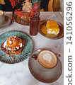 Cafe Brunch Table With Latte, Caramel Toast Dessert and Mango Cake on Marble 141056296