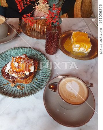 Cafe Brunch Table With Latte, Caramel Toast Dessert and Mango Cake on Marble Cafe Brunch Table With Latte, Caramel Toast Dessert and Mango Cake on Marble 141056296