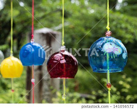 A scene of wind chimes swaying in the breeze A scene of wind chimes swaying in the breeze 141056572