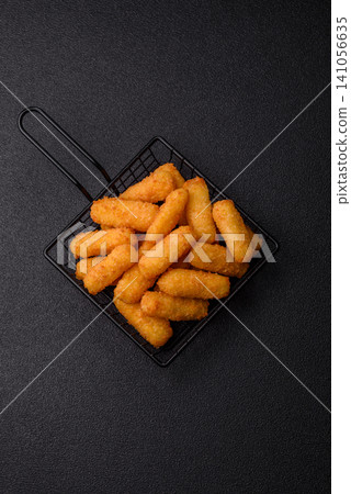 Mozzarella cheese sticks, breaded and fried with salt and tomato sauce, for takeaway. Cheese sticks Mozzarella cheese sticks, breaded and fried with salt and tomato sauce, for takeaway. Cheese sticks 141056635