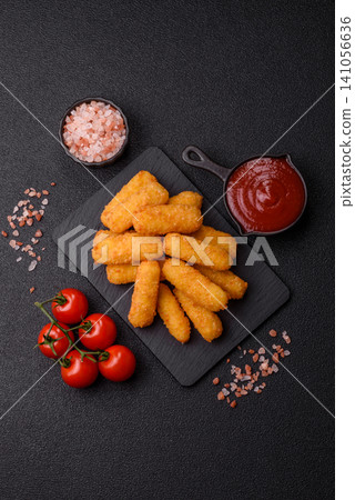 Mozzarella cheese sticks, breaded and fried with salt and tomato sauce, for takeaway. Cheese sticks Mozzarella cheese sticks, breaded and fried with salt and tomato sauce, for takeaway. Cheese sticks 141056636