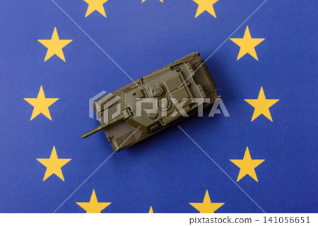 A tank on the European Union flag as a conceptual backdrop representing Europe's defense A tank on the European Union flag as a conceptual backdrop representing Europe's defense 141056651