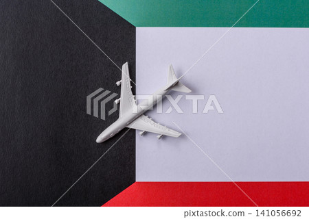 An airplane on the Kuwaiti flag as a conceptual backdrop for travel. An airplane on the Kuwaiti flag 141056692