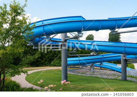 Blue waterslide at outdoor swimming pool Blue waterslide at outdoor swimming pool 141056803