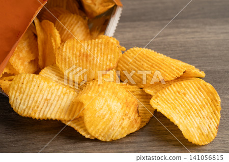 Potato chips , delicious BBQ seasoning spicy for crips, thin slice deep fried snack fast food. Potato chips , delicious BBQ seasoning spicy for crips, thin slice deep fried snack fast food. 141056815