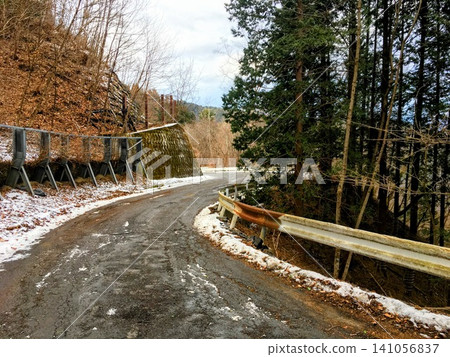 Rusty guardrail on a mountain road in winter Rusty guardrail on a mountain road in winter 141056837