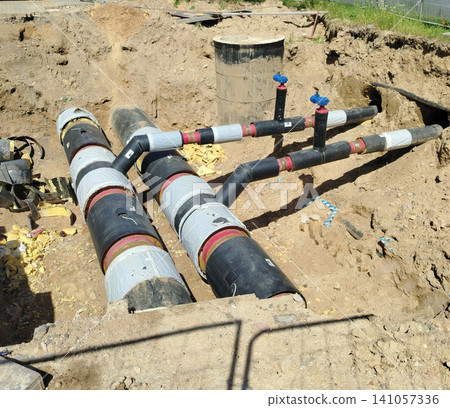 Underground Insulated District Heating Pipes in Construction Trench With Valves and Connections. Underground Insulated District Heating Pipes in Construction Trench With Valves and Connections. 141057336