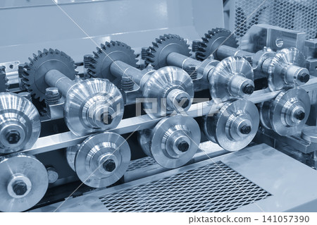 Industrial cold rolling process of sheet metal transporting on a roller conveyor system in a blue tone factory. Industrial cold rolling process of sheet metal transporting on a roller conveyor system in a blue tone factory. 141057390