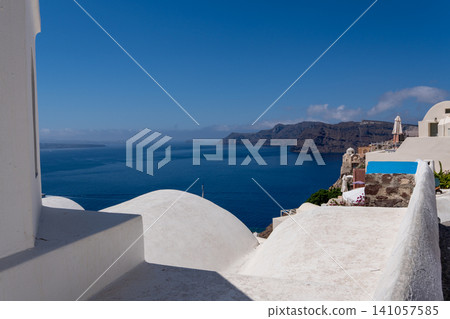 White rooftops of Oia overlooking Aegean Sea caldera in Santorini White rooftops of Oia overlooking Aegean Sea caldera in Santorini 141057585