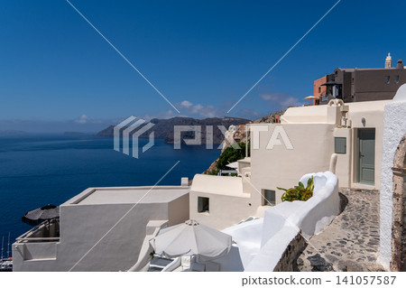 Scenic white hotels and paths in Oia overlooking Santorini caldera Scenic white hotels and paths in Oia overlooking Santorini caldera 141057587